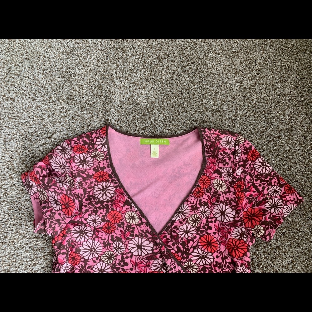 Wrap style blouse with raw edge (but stitched) bottom. Lots of detail.